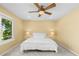 Inviting bedroom with natural light, ceiling fan and a view of the community at 15963 Rock Crystal Dr, Parker, CO 80134