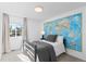 Comfortable bedroom with gray comforter, carpet, and large map wall decoration at 15963 Rock Crystal Dr, Parker, CO 80134