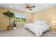 Sun-filled bedroom with ceiling fan, neutral carpet and large window view at 15963 Rock Crystal Dr, Parker, CO 80134