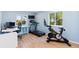 A bright, airy exercise room with hardwood floors, large windows, and modern equipment at 15963 Rock Crystal Dr, Parker, CO 80134