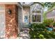 Charming front exterior with brick accents, large windows, and a beautifully landscaped front yard at 15963 Rock Crystal Dr, Parker, CO 80134