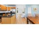 Modern kitchen open to hallway featuring stainless steel appliances and a granite countertop island at 15963 Rock Crystal Dr, Parker, CO 80134