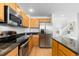Modern kitchen with granite countertops, a stainless steel refrigerator and light colored wood cabinetry at 15963 Rock Crystal Dr, Parker, CO 80134