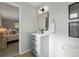 Bathroom vanity with modern fixtures, with a bedroom view through the doorway at 1905 S Linden Ct, Denver, CO 80224