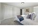 Cozy bedroom featuring white comforter, gray carpeting, and sliding closet doors at 1905 S Linden Ct, Denver, CO 80224