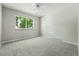 Neutral bedroom offers a ceiling fan and a window letting in natural light at 1905 S Linden Ct, Denver, CO 80224
