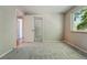 Bedroom with mirrored closet doors and a window letting in natural light at 1905 S Linden Ct, Denver, CO 80224