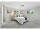Bright bedroom with light gray walls, gray carpeting, and multiple windows at 1905 S Linden Ct, Denver, CO 80224