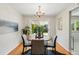Cozy dining room featuring a chandelier, wood floors, and sliding glass doors to the backyard at 1905 S Linden Ct, Denver, CO 80224