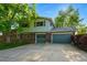 Two-story home with a well-kept lawn, mature trees, and a spacious three-car garage at 1905 S Linden Ct, Denver, CO 80224