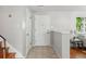 Bright foyer featuring tiled floor, entry door with a stained glass accent, closet and stair access at 1905 S Linden Ct, Denver, CO 80224