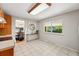 Bright kitchen featuring tile flooring, large window, and an adjacent dining area at 1905 S Linden Ct, Denver, CO 80224