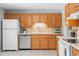 Close up of bright kitchen featuring tile backsplash and stainless steel dishwasher at 1905 S Linden Ct, Denver, CO 80224