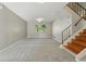 Spacious living room featuring a staircase and a window letting in natural light at 1905 S Linden Ct, Denver, CO 80224