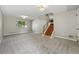 Spacious living room with new carpet, bright windows, and wood stairs at 1905 S Linden Ct, Denver, CO 80224
