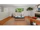 Comfortable living room with hardwood floors, a large window view, fireplace, and neutral color scheme at 1905 S Linden Ct, Denver, CO 80224