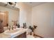 Cozy bathroom with decorative fixtures, vanity, and natural wood door at 995 Nob Hill Rd, Evergreen, CO 80439