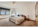 Comfortable bedroom featuring soft carpet, wooden trim, and a ceiling fan at 995 Nob Hill Rd, Evergreen, CO 80439