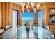 Elegant dining room with a unique chandelier, and picturesque mountain views at 995 Nob Hill Rd, Evergreen, CO 80439