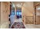 Bright foyer with tile flooring, staircase, and an open view into the living room with mountain views at 995 Nob Hill Rd, Evergreen, CO 80439