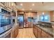 Spacious kitchen with stainless steel appliances, granite countertops, and wood cabinets at 995 Nob Hill Rd, Evergreen, CO 80439