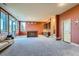 Open living area with a bar, stairs to the upper floor, and natural light at 995 Nob Hill Rd, Evergreen, CO 80439
