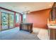 Bright living room boasting mountain views through large glass doors and a custom bar at 995 Nob Hill Rd, Evergreen, CO 80439