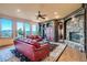 Comfortable living room with hardwood floors, stone fireplace, and scenic mountain views at 995 Nob Hill Rd, Evergreen, CO 80439