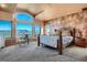 Spacious main bedroom featuring high ceilings, carpet floors, and a scenic mountain view from large picture windows at 995 Nob Hill Rd, Evergreen, CO 80439