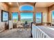 Well-lit bedroom featuring mountain views, carpet floors, light furniture and neutral paint colors at 995 Nob Hill Rd, Evergreen, CO 80439
