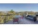 Relaxing outdoor deck featuring a sitting area and views of lush greenery at 995 Nob Hill Rd, Evergreen, CO 80439