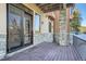 Charming outdoor deck featuring stone pillars, sliding glass doors, and a wood deck at 995 Nob Hill Rd, Evergreen, CO 80439