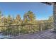 Beautiful deck offering scenic views of the surrounding mountains and trees at 995 Nob Hill Rd, Evergreen, CO 80439