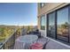 Scenic outdoor deck with mountain views, outdoor seating, and access to the home at 995 Nob Hill Rd, Evergreen, CO 80439