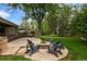 Beautiful backyard with a fire pit, mature trees, and patio offers a relaxing space at 5340 S Logan Dr, Greenwood Village, CO 80121