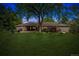 Backyard view featuring a well-manicured lawn and large trees providing shade and privacy at 5340 S Logan Dr, Greenwood Village, CO 80121