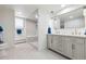 Bright bathroom with updated vanity and large mirror, and a modern glass shower with seat at 5340 S Logan Dr, Greenwood Village, CO 80121