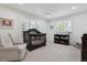 Bright Bedroom featuring a dark wood crib, comfortable armchair, and ample natural light at 5340 S Logan Dr, Greenwood Village, CO 80121