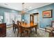 Formal dining room with elegant light fixture, hardwood floors, and large window with plantation shutters at 5340 S Logan Dr, Greenwood Village, CO 80121
