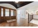 Bright foyer with hardwood floors, staircase with iron railing, and a view into the living spaces at 5340 S Logan Dr, Greenwood Village, CO 80121
