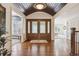Grand foyer featuring hardwood floors, high ceilings, and stunning double doors with leaded glass at 5340 S Logan Dr, Greenwood Village, CO 80121