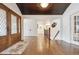 Bright foyer with hardwood floors, staircase with iron railing, and view to the living room at 5340 S Logan Dr, Greenwood Village, CO 80121