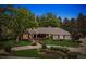 Charming front exterior with mature landscaping and a curved walkway leading to the entrance at 5340 S Logan Dr, Greenwood Village, CO 80121