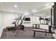 Home gym with large mirror, treadmill, exercise bike, and bench for workouts at 5340 S Logan Dr, Greenwood Village, CO 80121