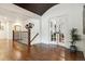 Hallway with hardwood floors and a staircase with iron railing leading to the upper level at 5340 S Logan Dr, Greenwood Village, CO 80121