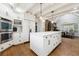 Bright kitchen featuring white cabinetry, an island with sink, granite counters and hardwood floors at 5340 S Logan Dr, Greenwood Village, CO 80121