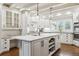 Bright kitchen featuring white cabinetry, an island with sink, granite counters and hardwood floors at 5340 S Logan Dr, Greenwood Village, CO 80121