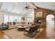 Spacious living room featuring a vaulted ceiling, stone fireplace, and comfortable seating area at 5340 S Logan Dr, Greenwood Village, CO 80121