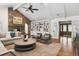 Cozy living room featuring a vaulted ceiling, stone fireplace, and built-in bookshelves at 5340 S Logan Dr, Greenwood Village, CO 80121