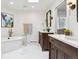 Bright bathroom with dual vanity sinks, soaking tub and views to the backyard at 5340 S Logan Dr, Greenwood Village, CO 80121